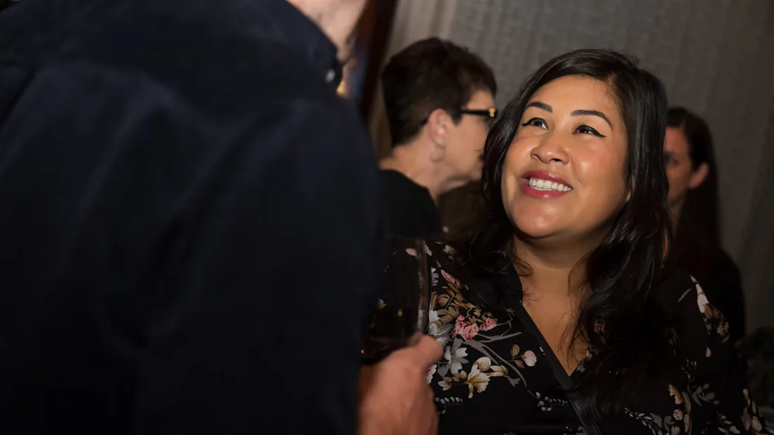 Flor De Maria McNally laughing with agents at a Mega Moms gathering
