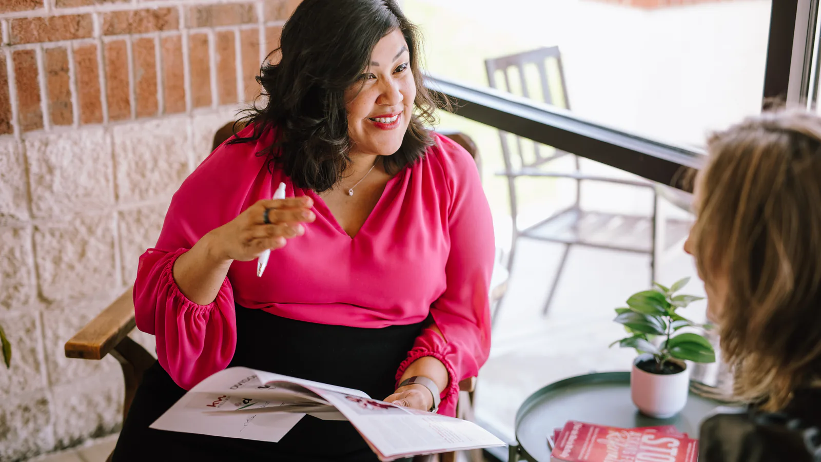 Flor De Maria McNally coaching a real estate agent at a table