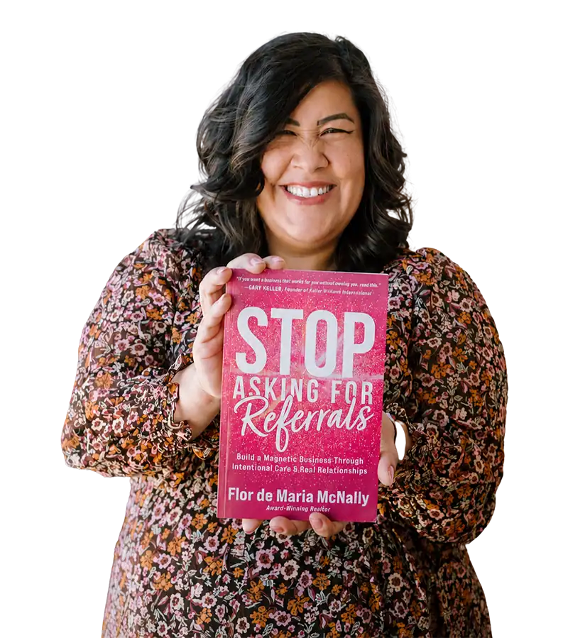 Flor De Maria McNally smiling and holding her book Stop Asking for Referrals